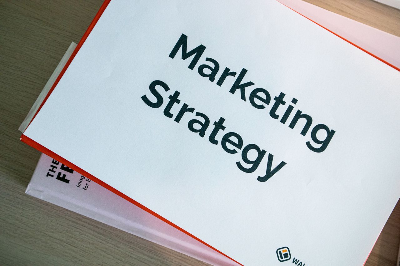 team-02 A marketing strategy document displayed on a desk, showcasing business planning essentials.